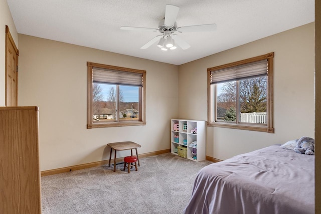 carpeted bedroom with baseboards and ceiling fan