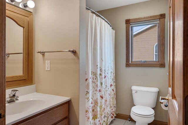 bathroom featuring vanity, a shower with shower curtain, toilet, and tile patterned floors