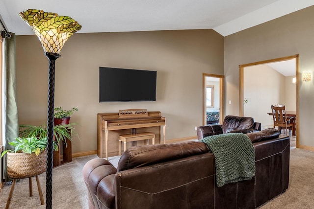 carpeted living room with baseboards and vaulted ceiling