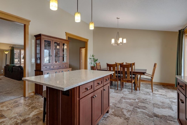 kitchen featuring glass insert cabinets, baseboards, decorative light fixtures, a kitchen bar, and a notable chandelier