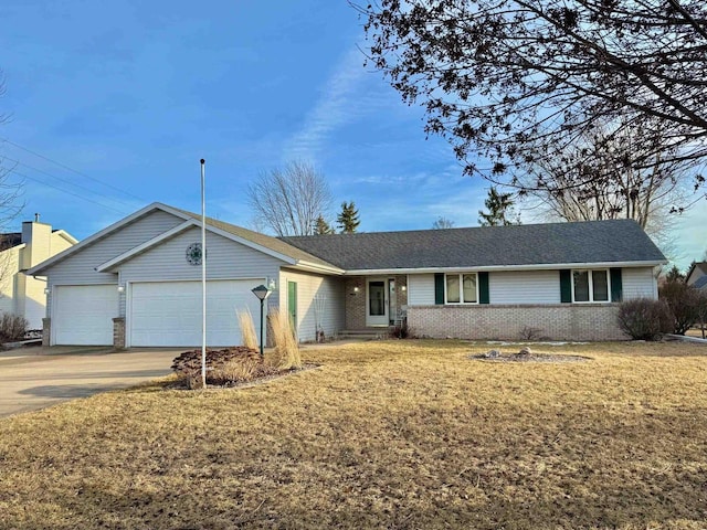 ranch-style home with brick siding, an attached garage, concrete driveway, and a front yard