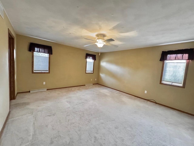 unfurnished room with visible vents, light carpet, baseboards, and a ceiling fan