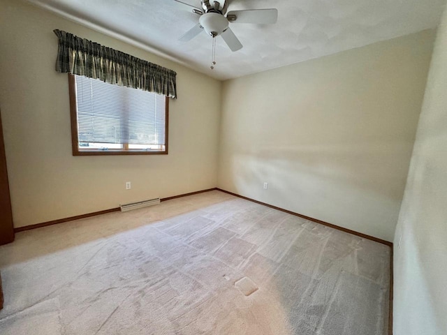 carpeted spare room featuring a ceiling fan, baseboards, and visible vents