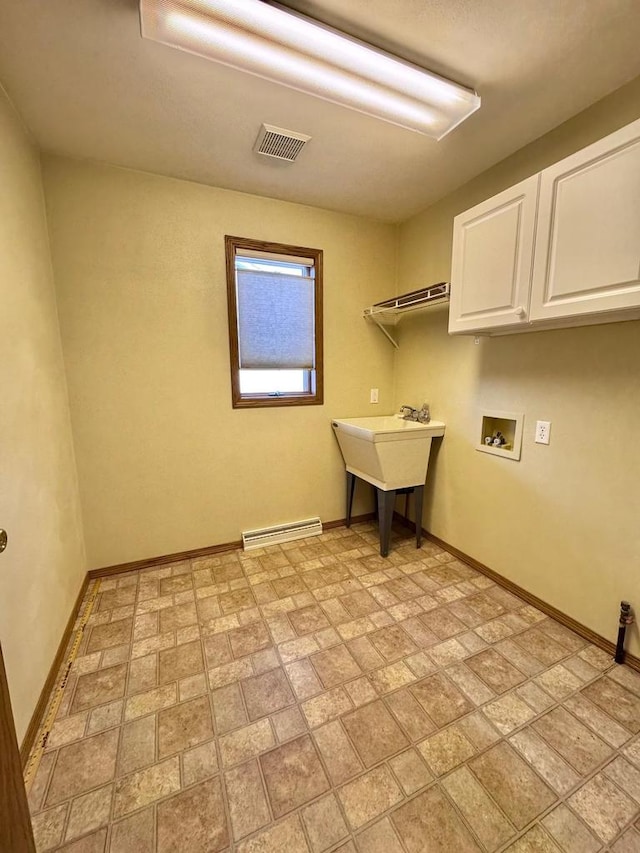 washroom featuring visible vents, washer hookup, cabinet space, a baseboard radiator, and baseboards