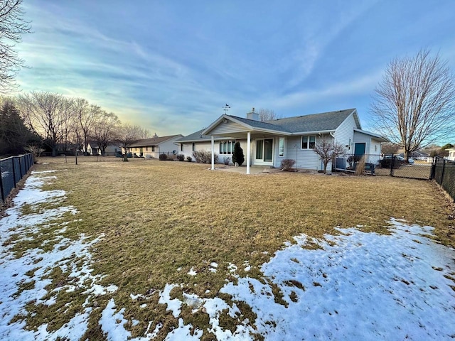 snow covered property featuring a yard and fence private yard