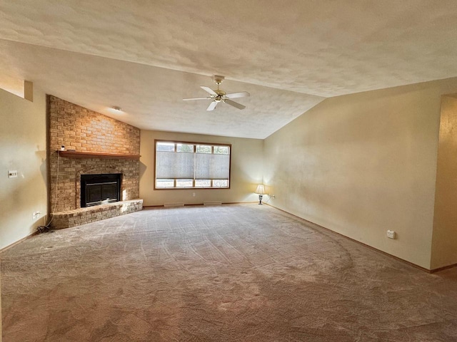 unfurnished living room featuring a brick fireplace, ceiling fan, carpet, lofted ceiling, and a textured ceiling