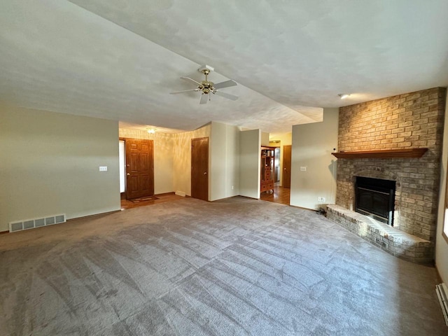 unfurnished living room featuring carpet, a fireplace, visible vents, and ceiling fan