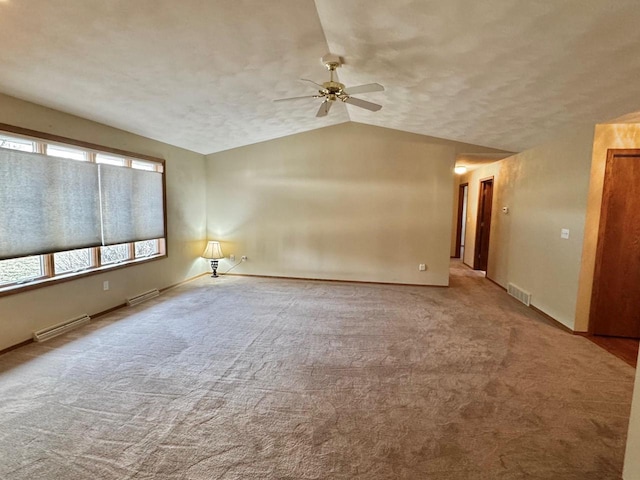 spare room with visible vents, lofted ceiling, and carpet floors