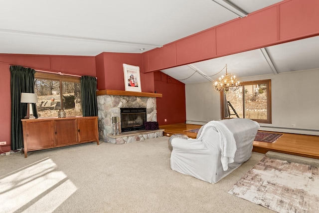 carpeted living room with a baseboard radiator, an inviting chandelier, a stone fireplace, vaulted ceiling, and a baseboard heating unit