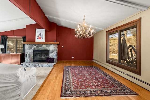 living room featuring hardwood / wood-style flooring, a baseboard heating unit, an inviting chandelier, a stone fireplace, and vaulted ceiling with beams