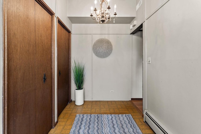 entrance foyer featuring a baseboard radiator, a notable chandelier, and visible vents