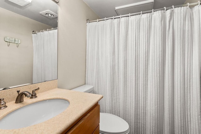 full bath with vanity, toilet, and visible vents