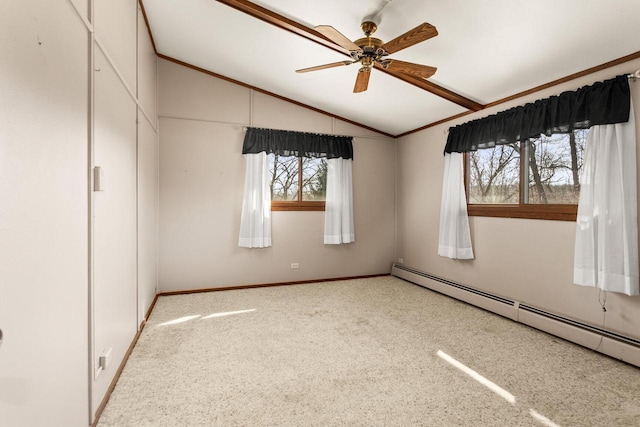 empty room with carpet flooring, lofted ceiling, plenty of natural light, and baseboard heating