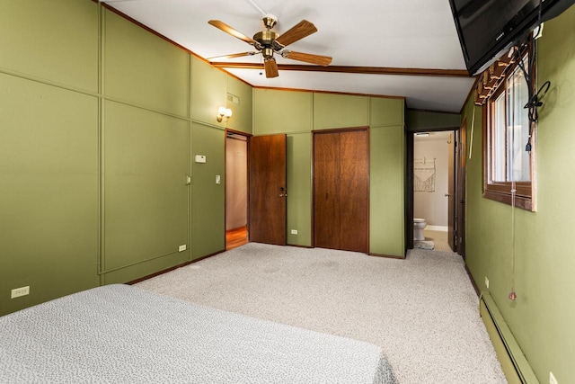 carpeted bedroom with ensuite bathroom, a baseboard heating unit, ceiling fan, and vaulted ceiling