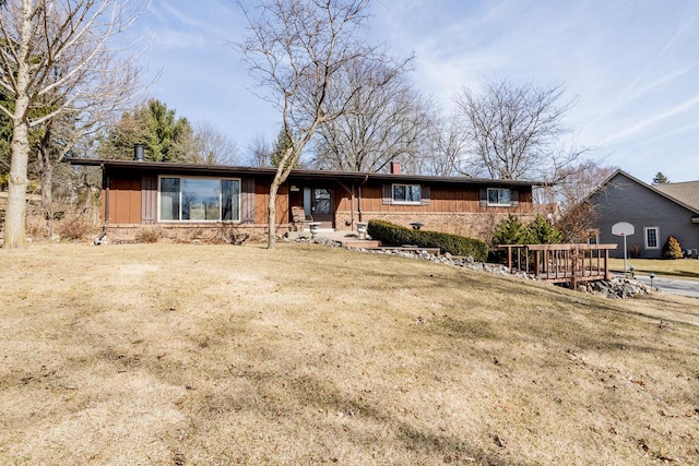 single story home with a chimney and a front lawn