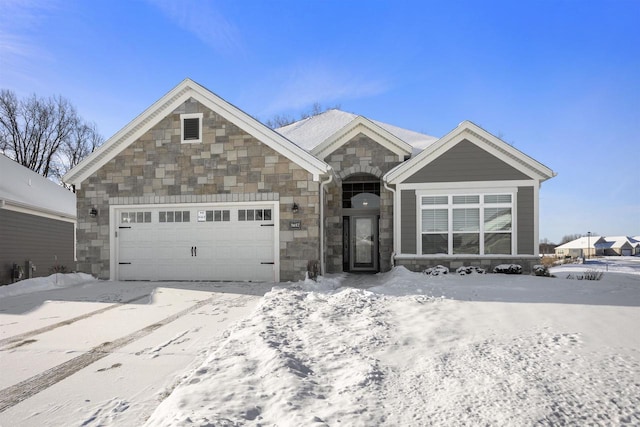 view of front facade featuring an attached garage and stone siding