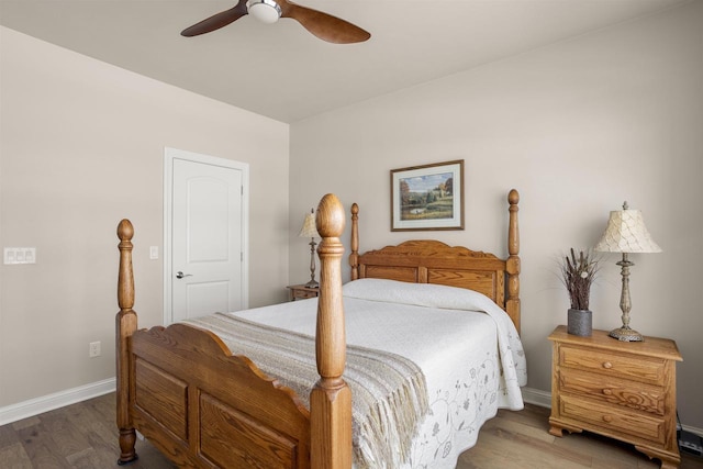 bedroom featuring ceiling fan, baseboards, and wood finished floors