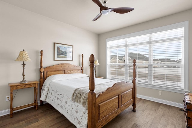 bedroom featuring wood finished floors, baseboards, and ceiling fan