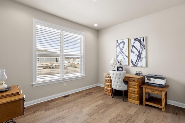 home office with light wood-style floors, visible vents, and baseboards