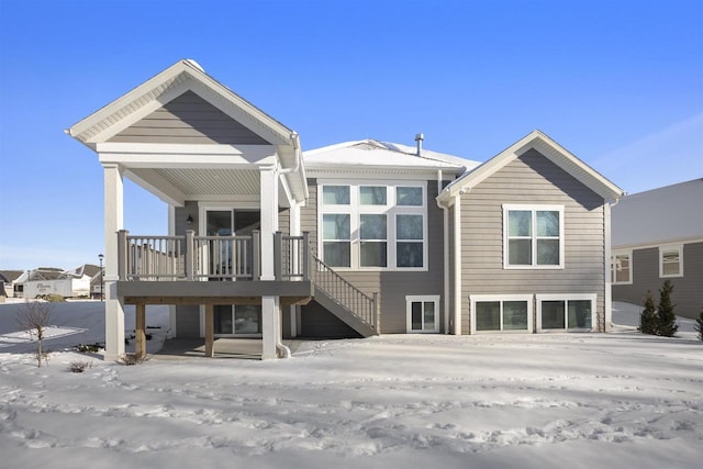 snow covered property featuring stairs