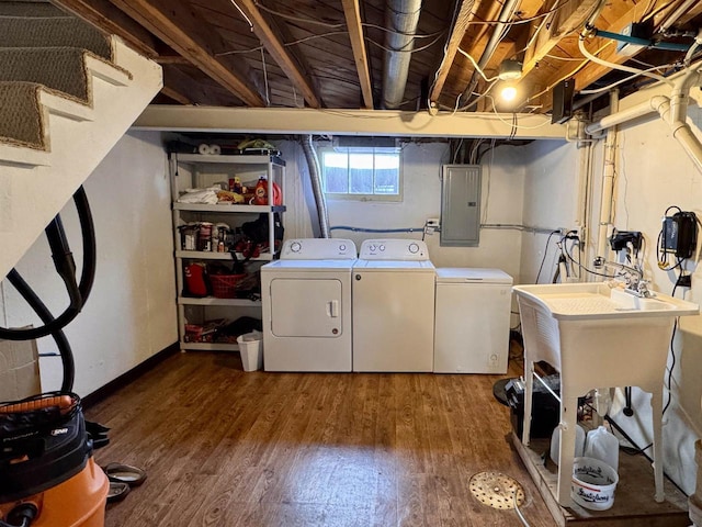 laundry room with electric panel, laundry area, separate washer and dryer, and wood finished floors