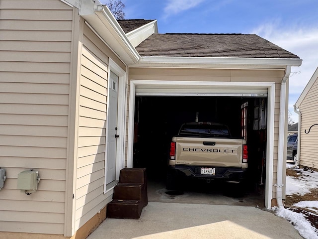 garage featuring concrete driveway