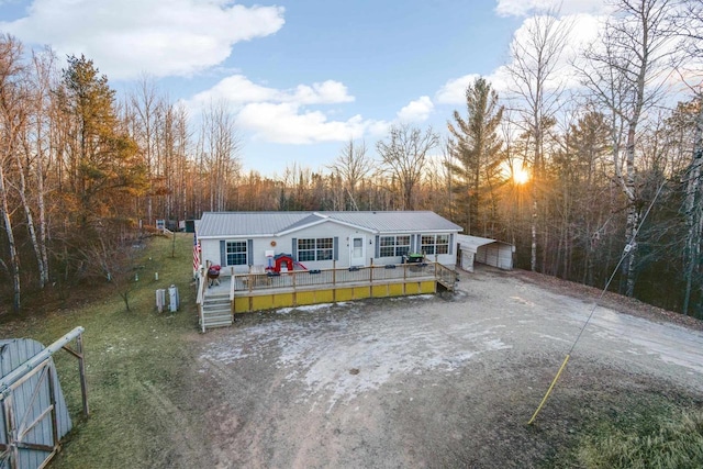 view of front of home featuring metal roof and a wooden deck