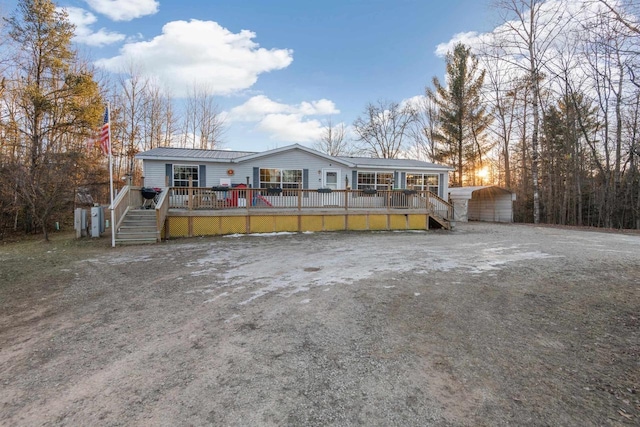 manufactured / mobile home featuring a deck and a carport