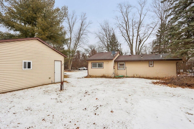 view of snow covered rear of property