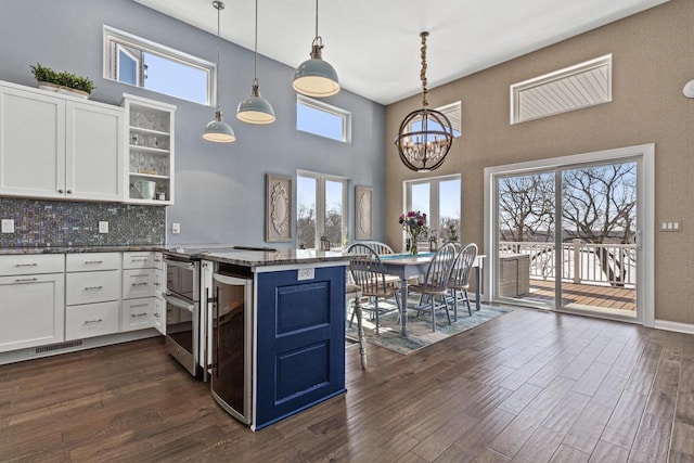 kitchen featuring open shelves, white cabinets, dark wood-style floors, and visible vents