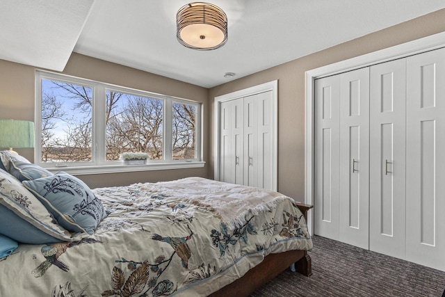 bedroom with carpet flooring and two closets