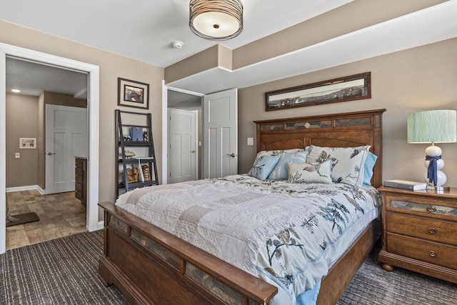 bedroom with baseboards and wood finished floors