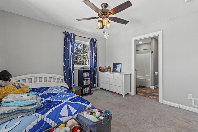 carpeted bedroom featuring connected bathroom, baseboards, visible vents, and a ceiling fan