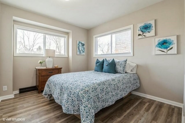 bedroom with baseboards and wood finished floors