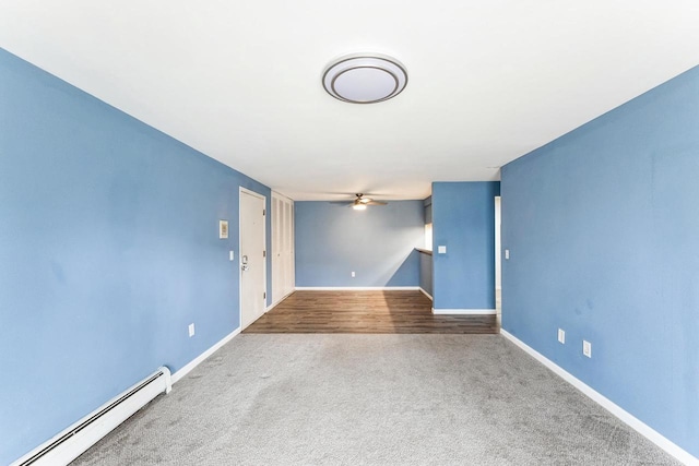 carpeted empty room with ceiling fan, baseboards, and a baseboard radiator