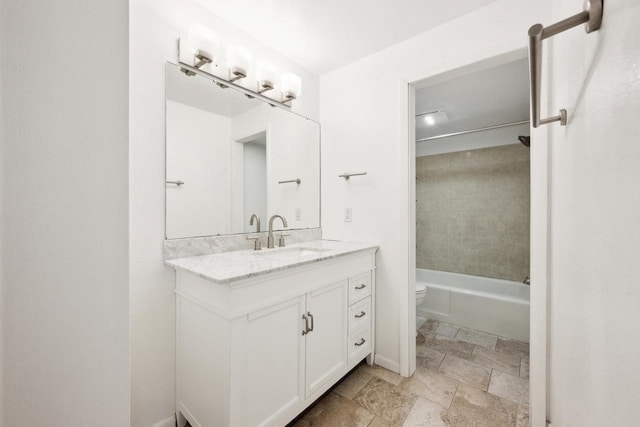 bathroom featuring stone finish flooring, toilet, bathtub / shower combination, and vanity