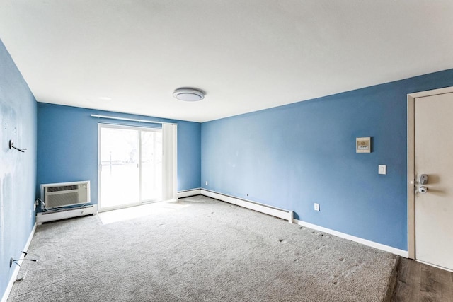 empty room featuring a wall mounted air conditioner, baseboards, carpet floors, and baseboard heating