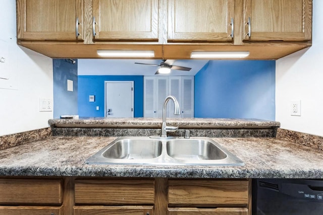 kitchen with a sink, black dishwasher, dark countertops, and a ceiling fan