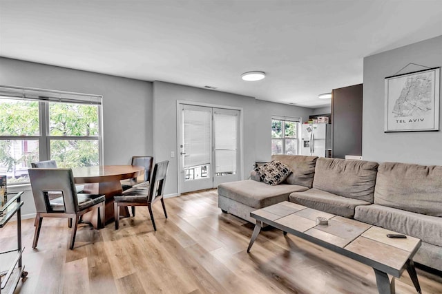 living room featuring light wood-type flooring and baseboards