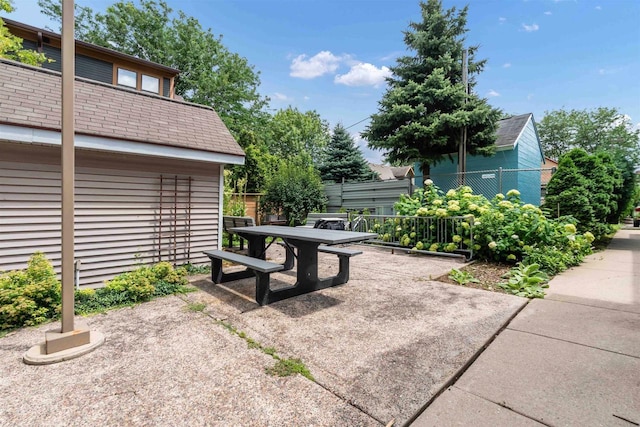 view of patio with outdoor dining area and fence