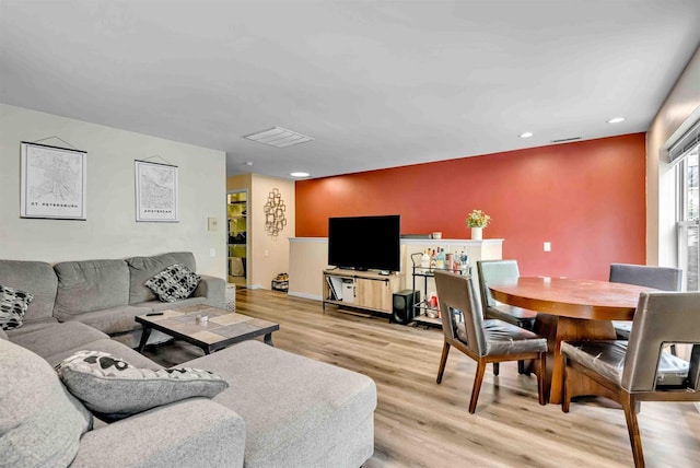 living room with visible vents, recessed lighting, and light wood-type flooring