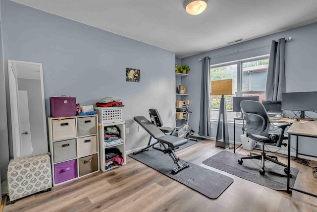 home office with visible vents, baseboards, and wood finished floors