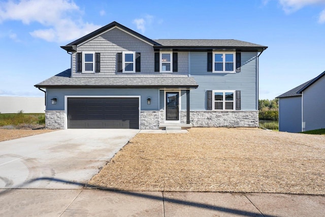 view of front of house with a garage, stone siding, and concrete driveway