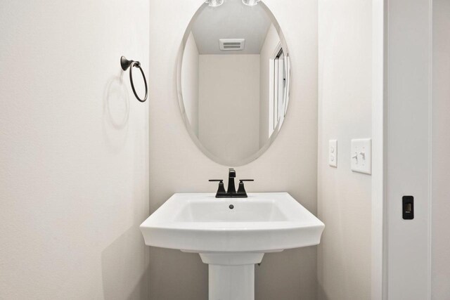 bathroom featuring visible vents and a sink