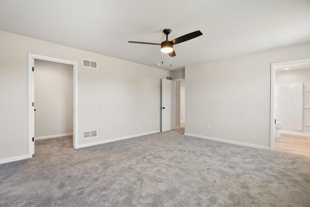 unfurnished bedroom with visible vents, a spacious closet, and carpet flooring