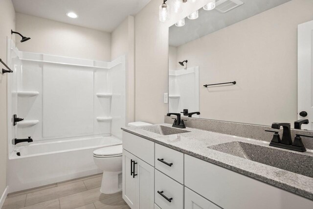 full bath with shower / bath combination, toilet, visible vents, and a sink