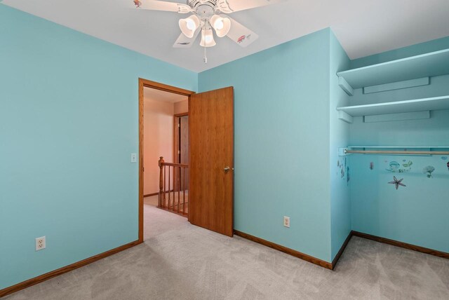 unfurnished bedroom with baseboards, a closet, and carpet flooring