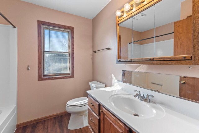 full bathroom with visible vents, baseboards, toilet, wood finished floors, and vanity