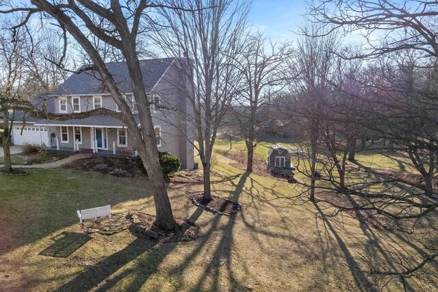 view of side of home with a porch and a yard