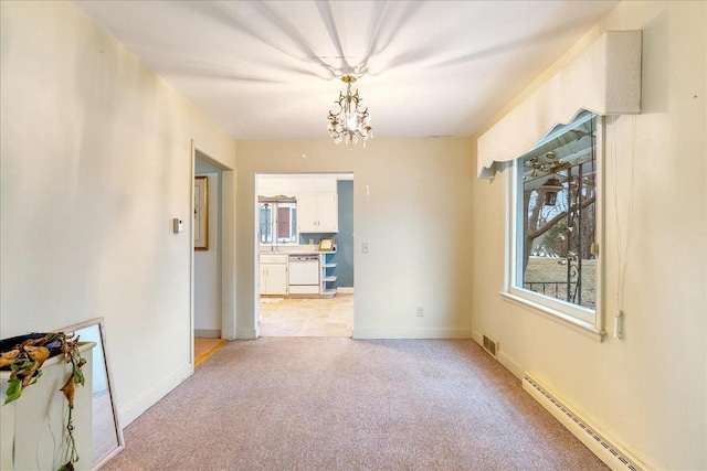 dining space featuring visible vents, light carpet, a notable chandelier, a baseboard heating unit, and baseboards